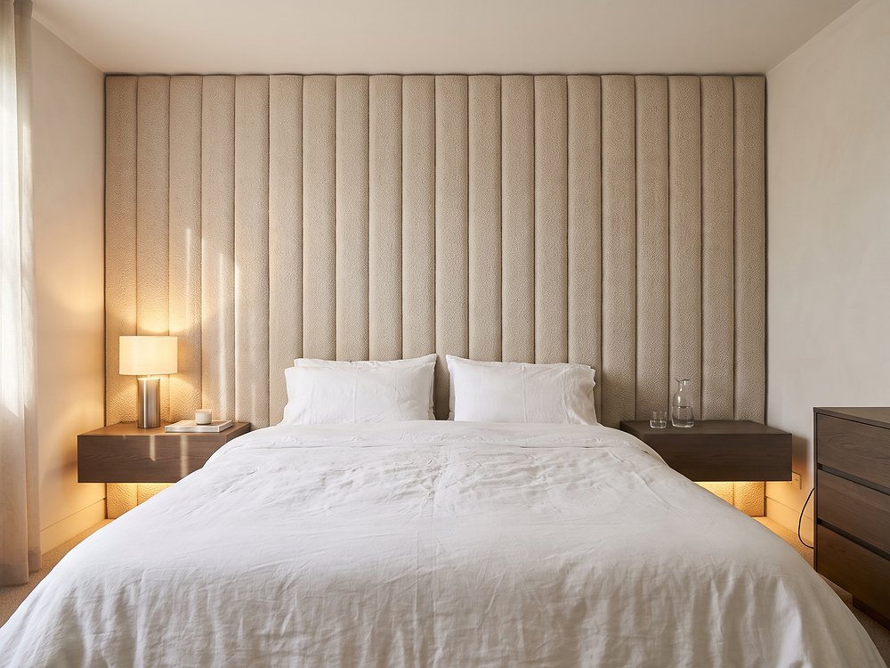 Upholstered bed with matching bedside units and media wall