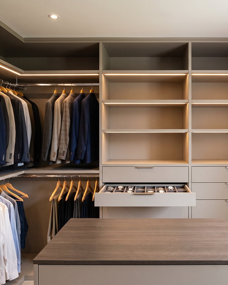 Walk-in wardrobe with LED-lit open shelving