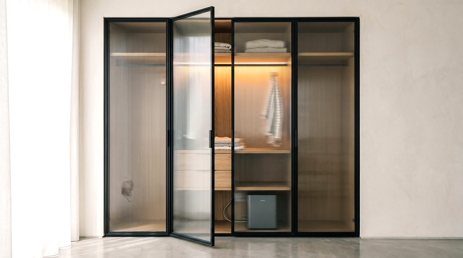 Fluted glass wardrobe doors with warm light behind